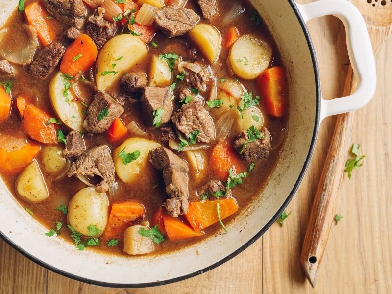 A hearty beef and vegetable stew in a cast iron pot, perfect for simple winter food ideas to enjoy during cold winter days.